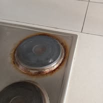 Close-up of rusty stove burner before deep cleaning